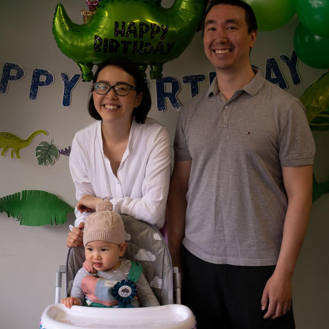Joelene and Tom standing behind baby son Jude who is in a high chair
